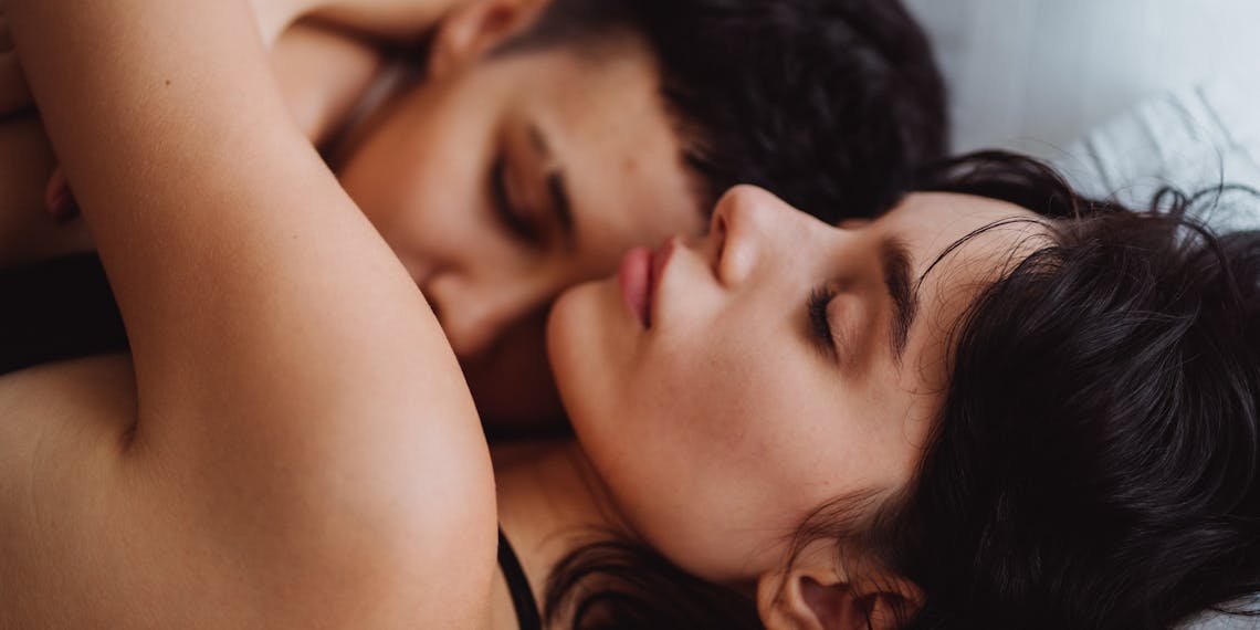 A tender embrace between a loving couple, showcasing intimacy and affection indoors.