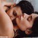 A tender embrace between a loving couple, showcasing intimacy and affection indoors.
