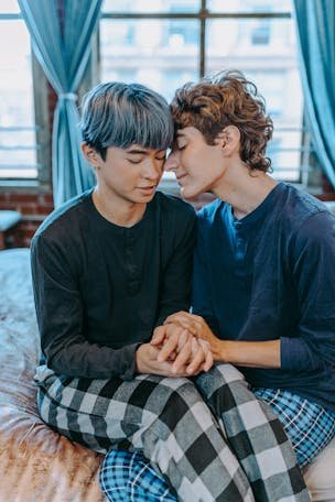 Tender moment between a couple embracing affectionately at home.